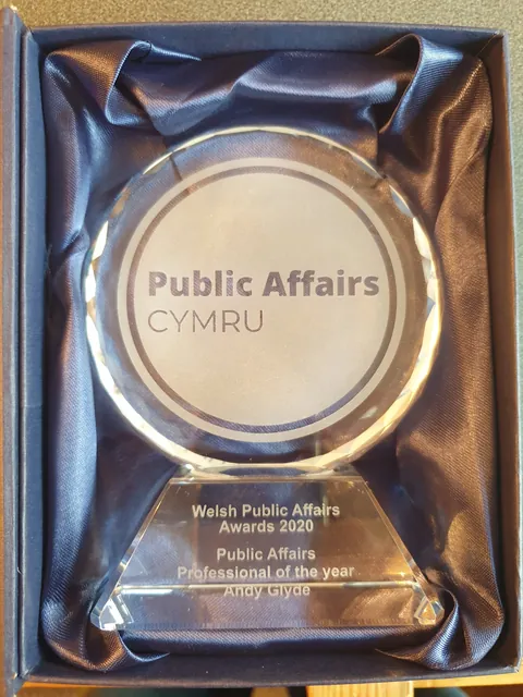 Engraved round crystal award in a blue satin-lined presentation box