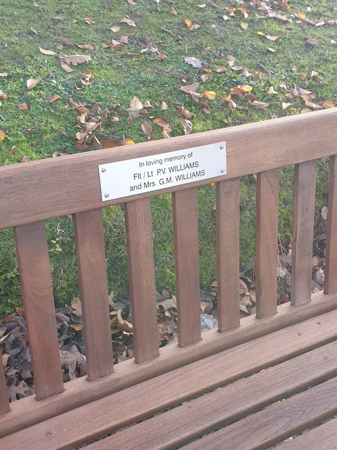 Small stainless steel bench plaque reading In loving memory with two names